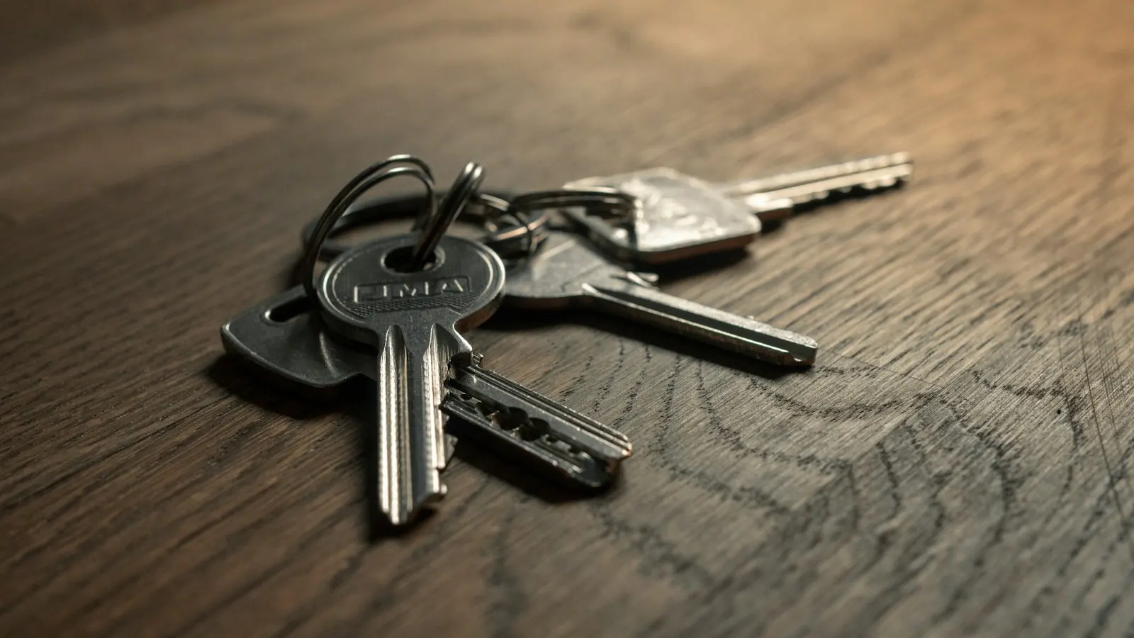 House keys resting on a wooden table.