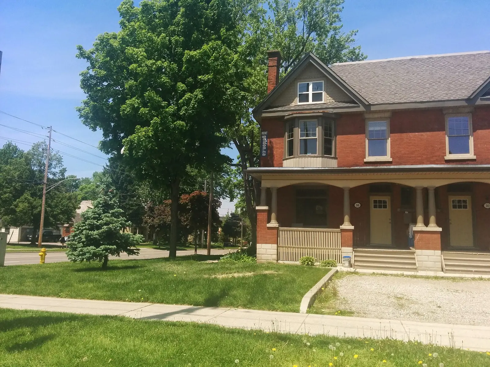 A red-brick duplex with a bay window and porch in Woodfield, London, Ontario. The file page does not name the street.