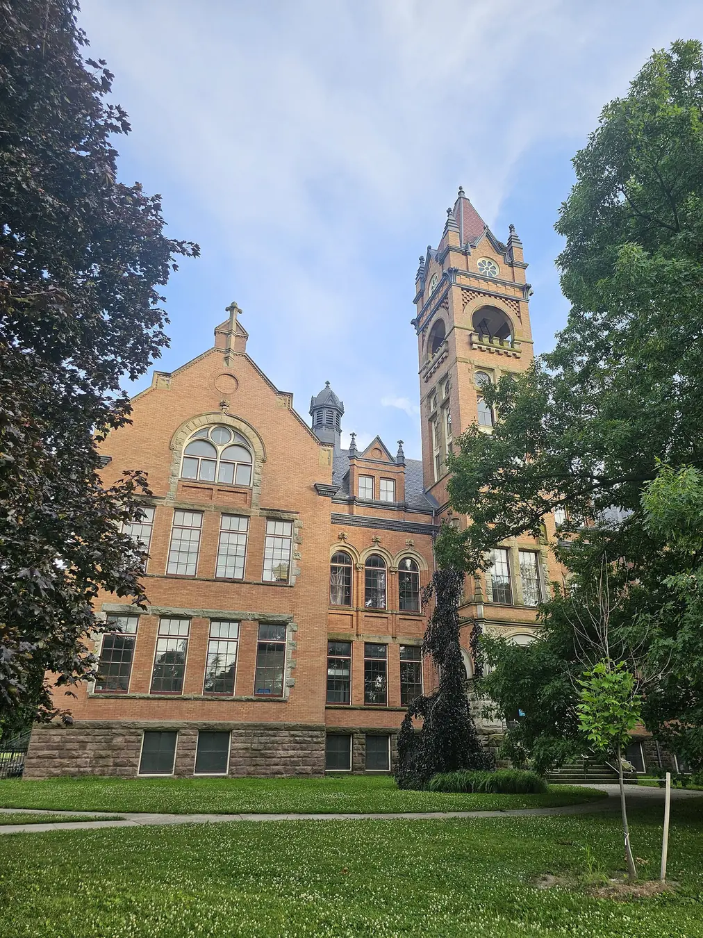 The brick facade and clock tower of the former London Normal School in Wortley Village, London, Ontario, now a YMCA.